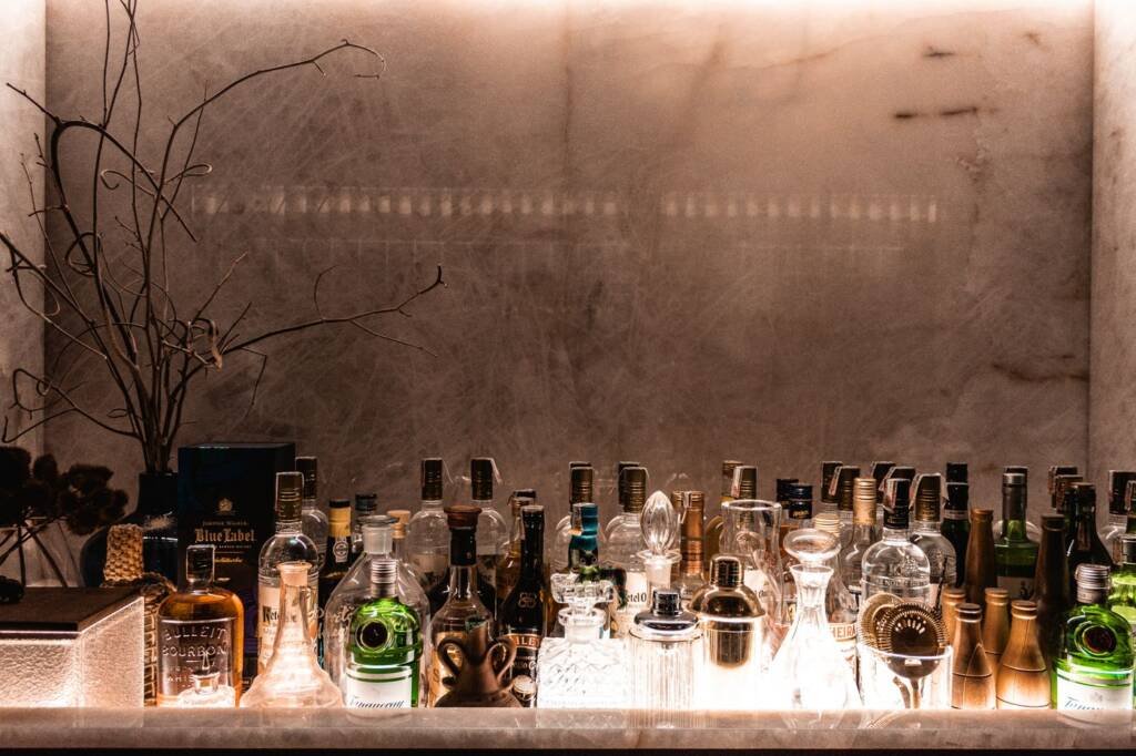 A well-stocked home bar with glassware and bottles on display