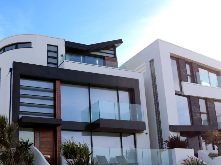 Contemporary luxury home front elevation with glass balconies