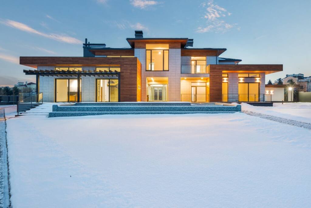 Illuminated two-storey villa front elevation at dusk