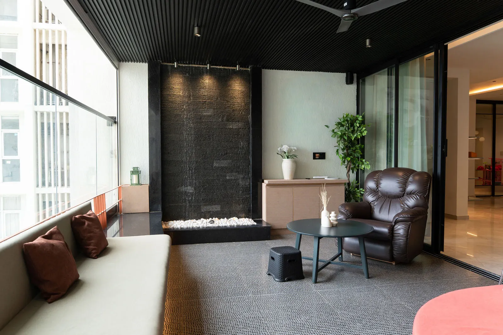 Balcony sit-out with cane seating and a planter