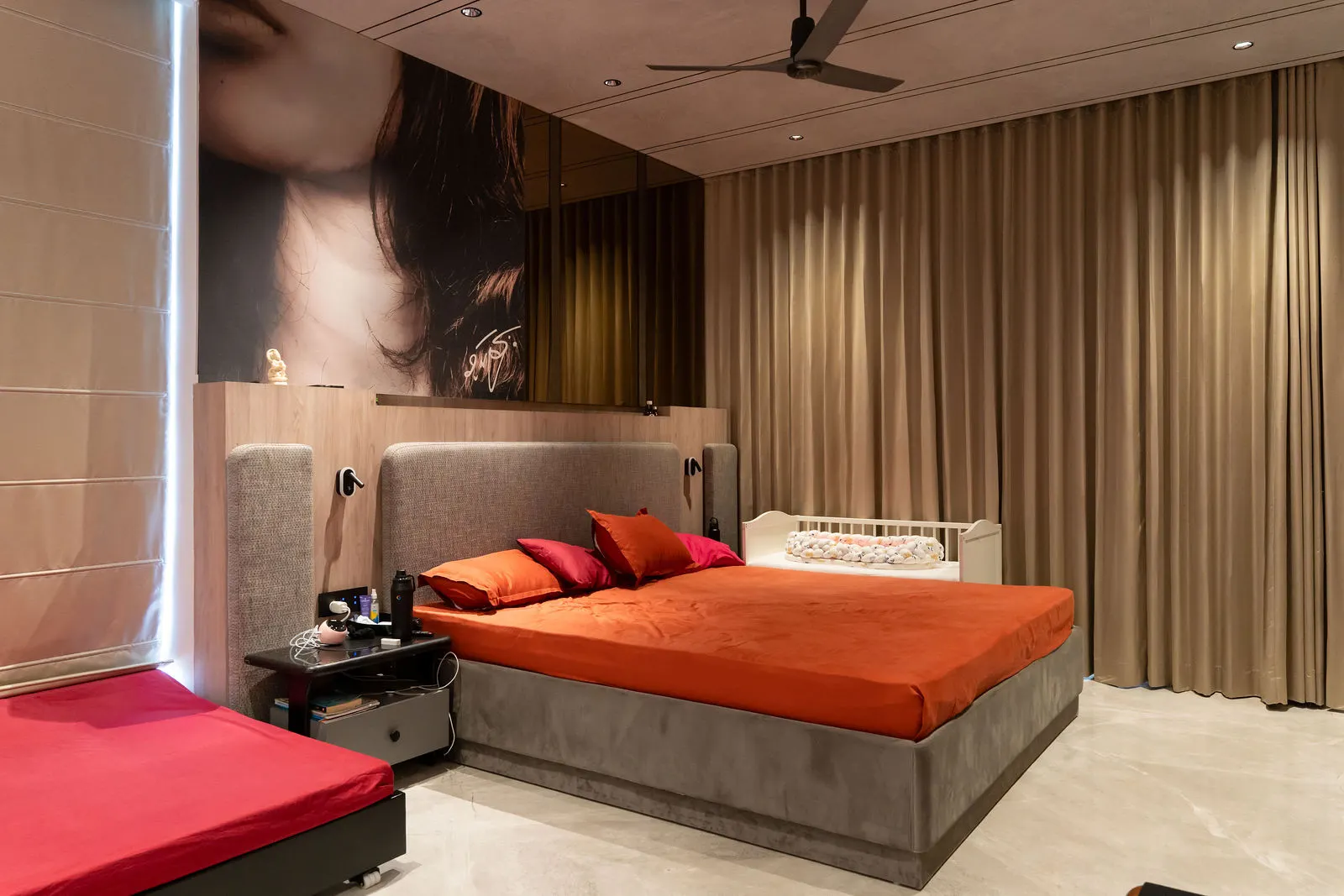 Guest bedroom with dark panelling and a warm bedspread