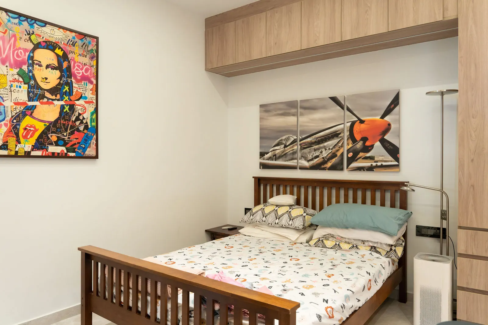 Bedroom with a wooden bed and a bold pop-art panel