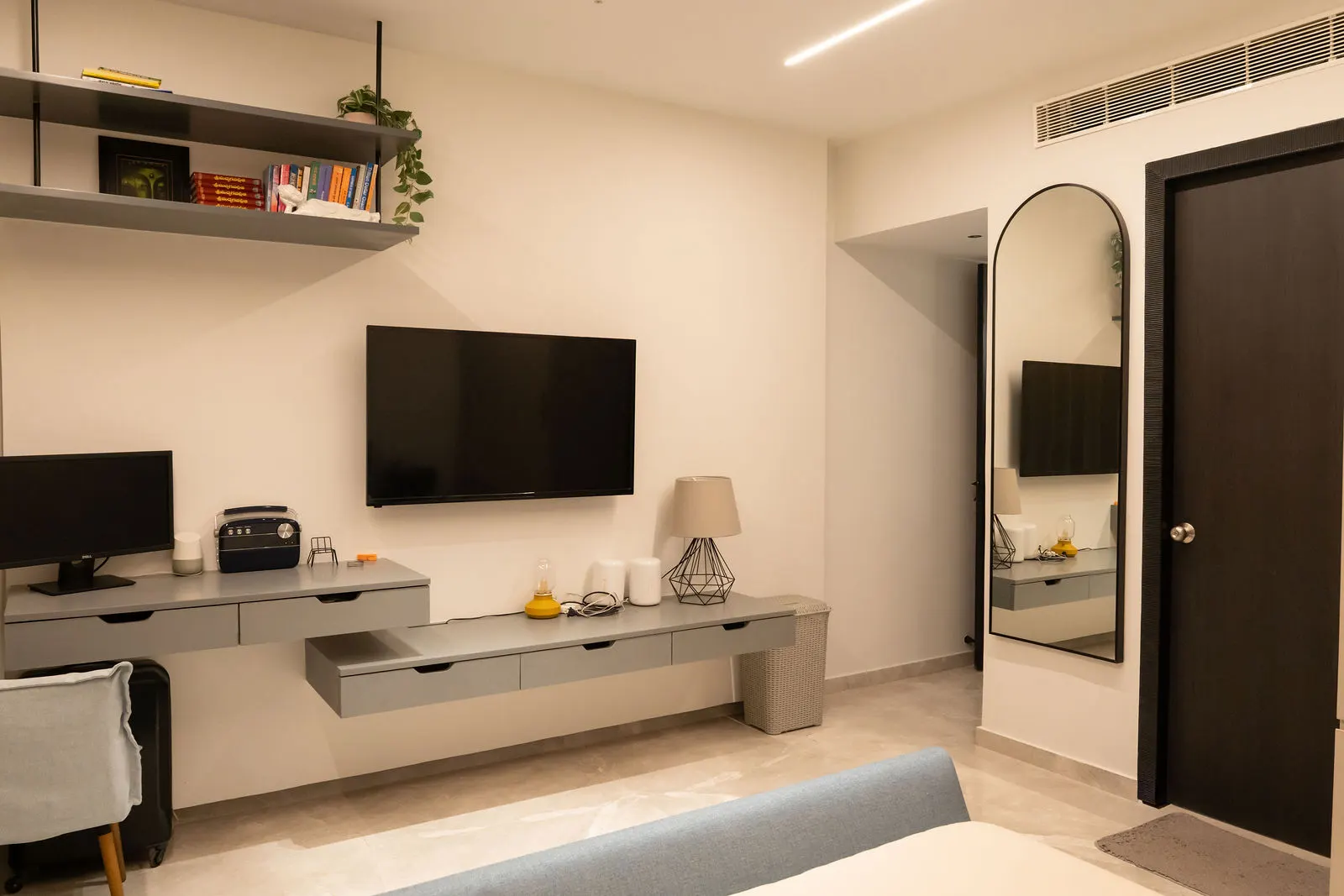 Bedroom TV wall with a floating wood console