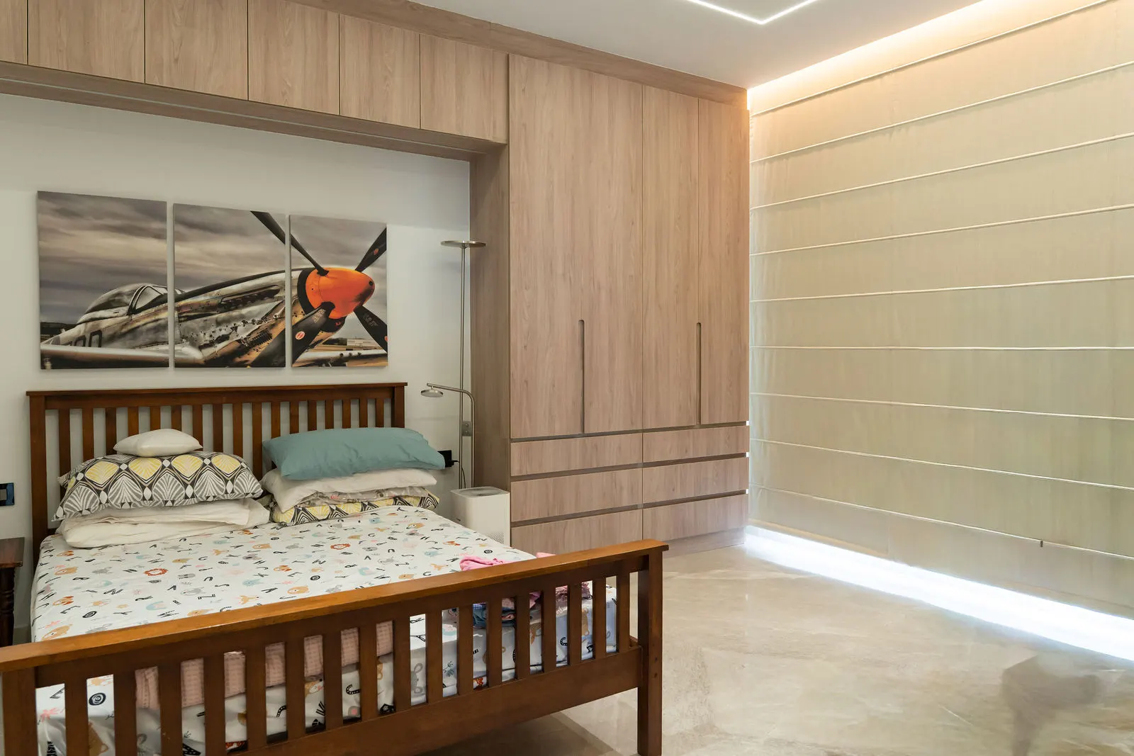 Bedroom with a solid wood bed and slatted headboard