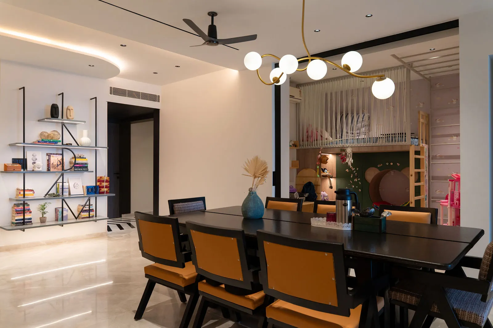 Dining table beside the kitchen counter in an open-plan 4 BHK