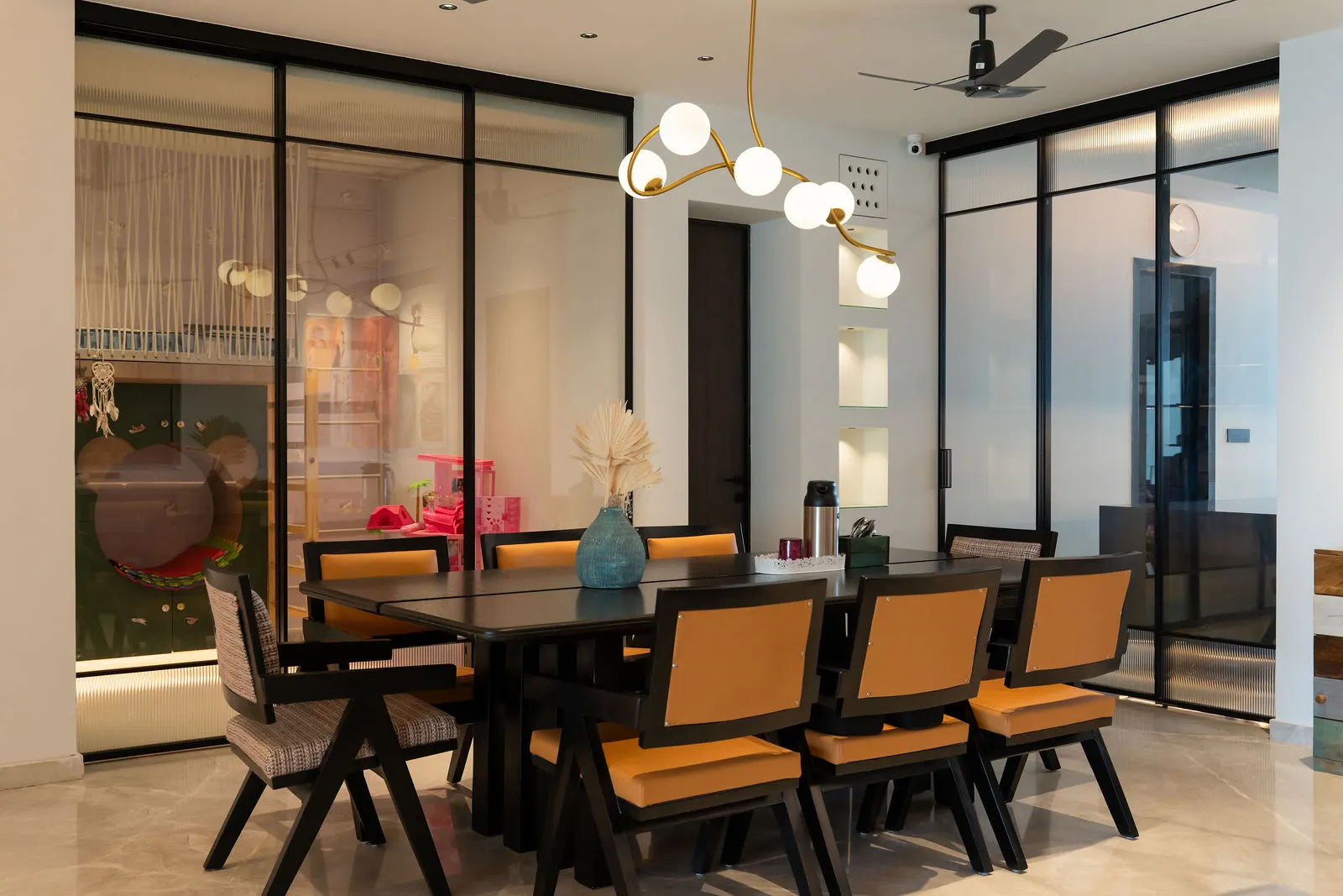 Dining seating framed by a fluted glass partition
