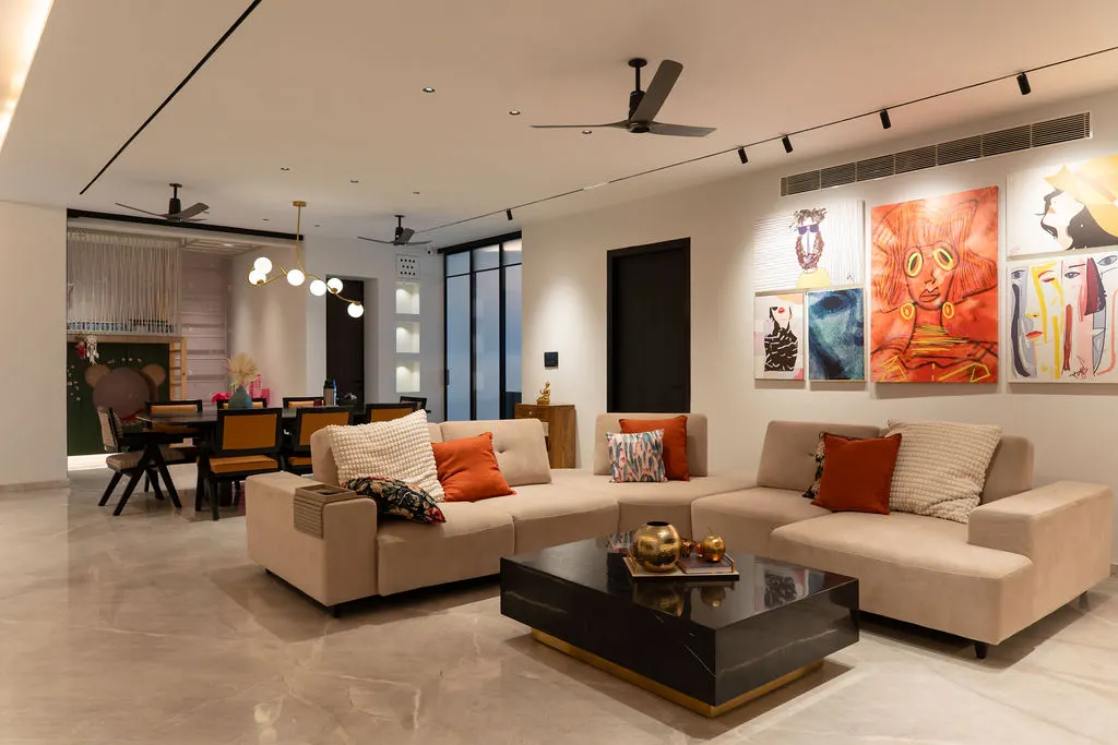 Open-plan living room with sectional sofa and art wall, Lodha Residence