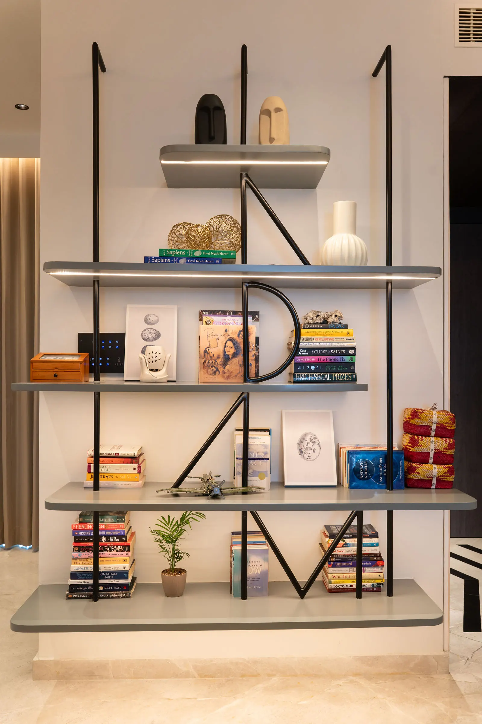 Slim metal open shelving used as a room divider