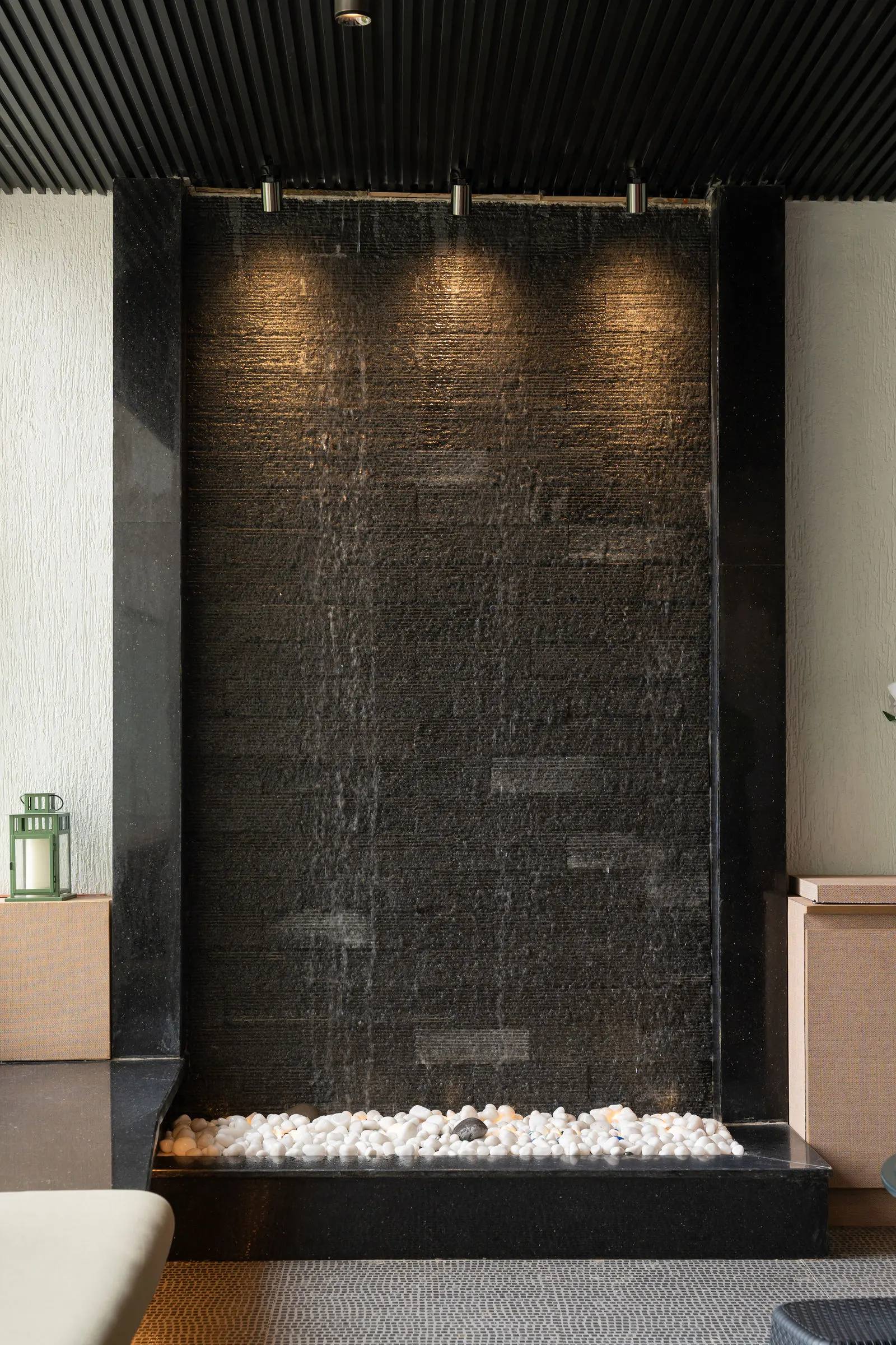 Textured stone feature wall with a water detail