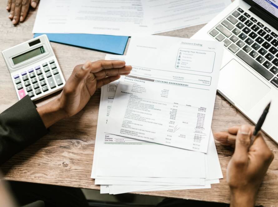 Bank documents, calculator and laptop used to plan construction payments