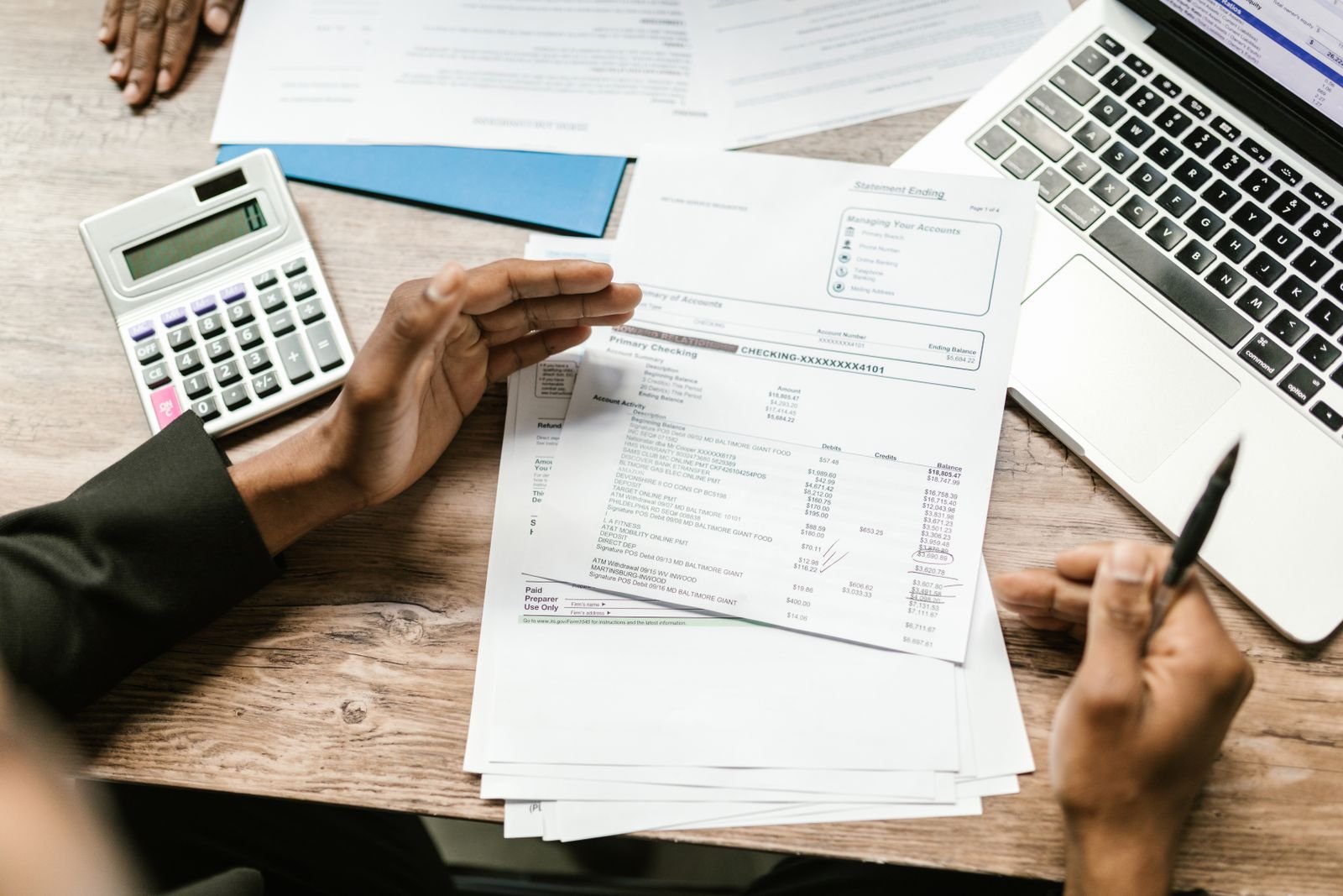 Bank documents, calculator and laptop used to plan construction payments in India