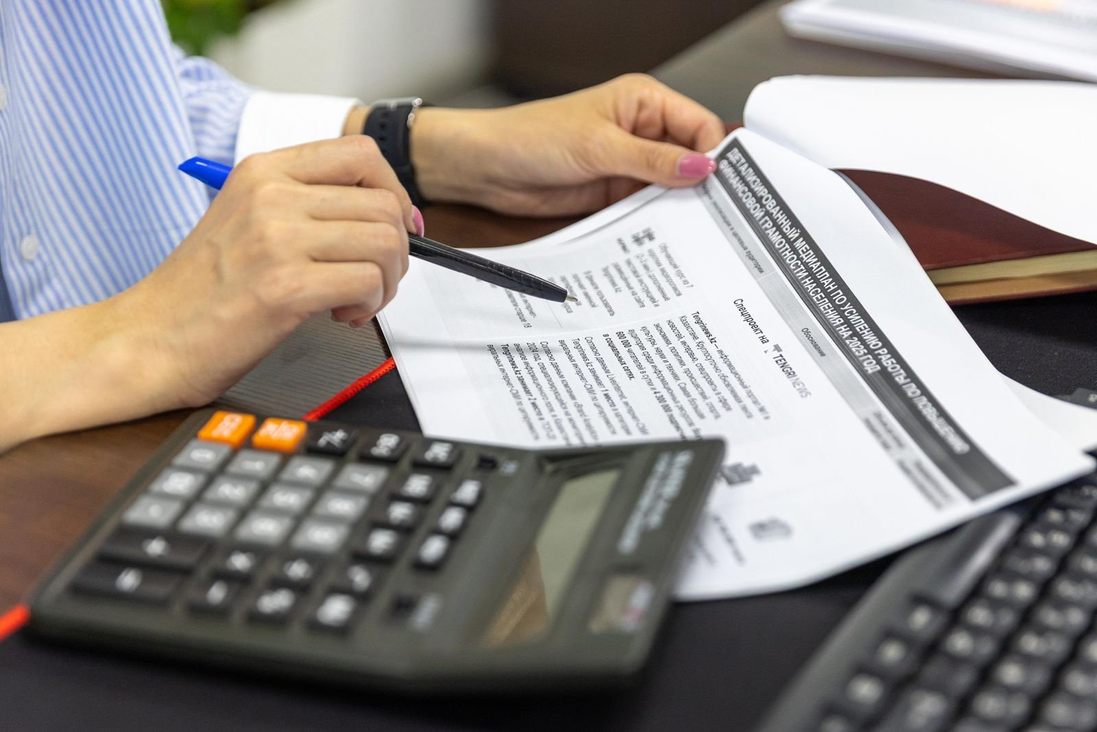 Reviewing loan documents with a calculator and pen