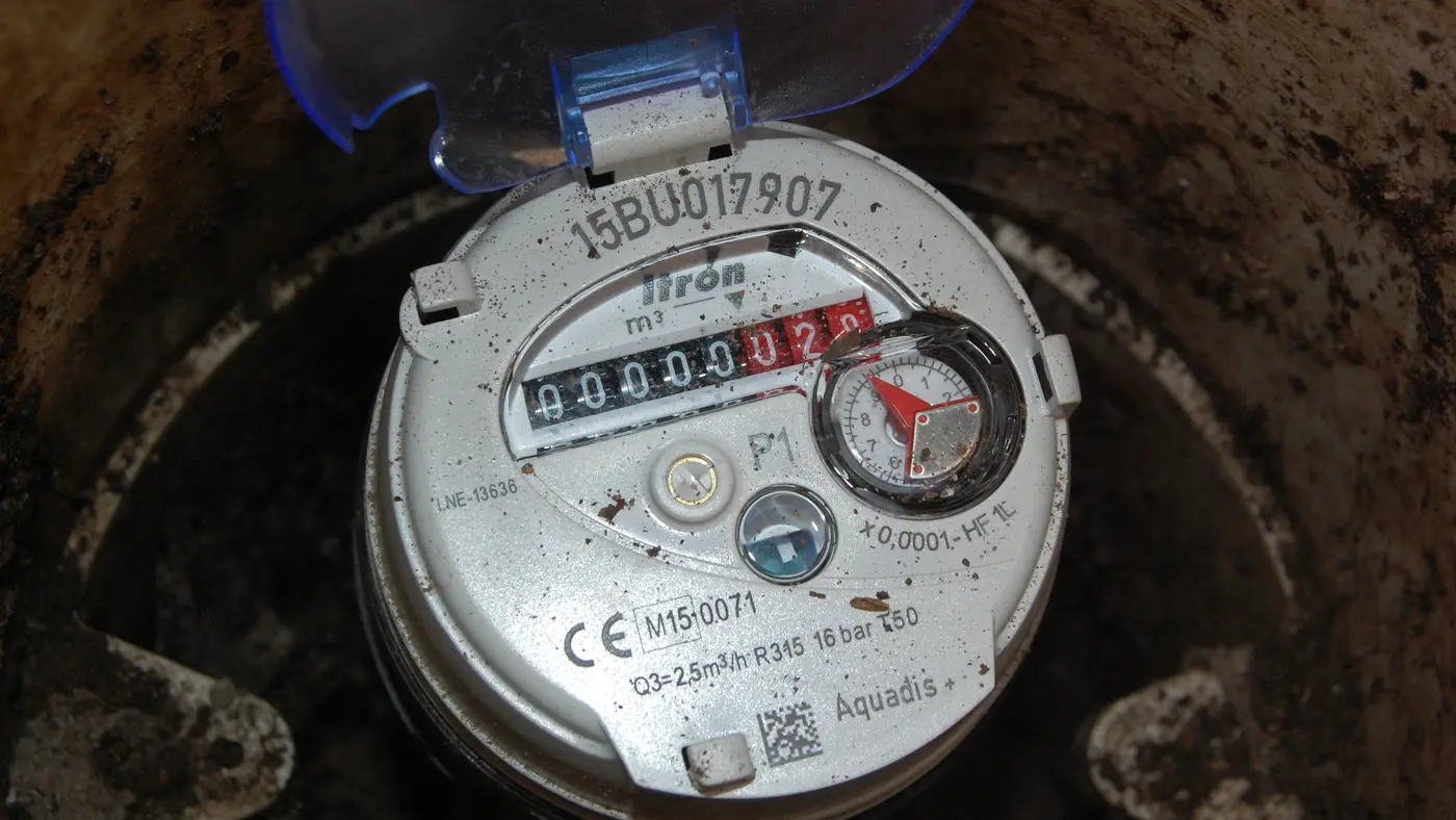 A domestic water meter installed in a chamber