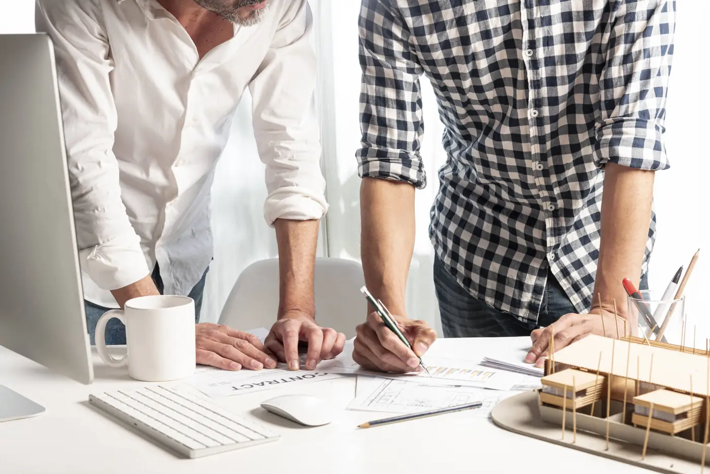 Architect and owner reviewing house drawings before applying for permission